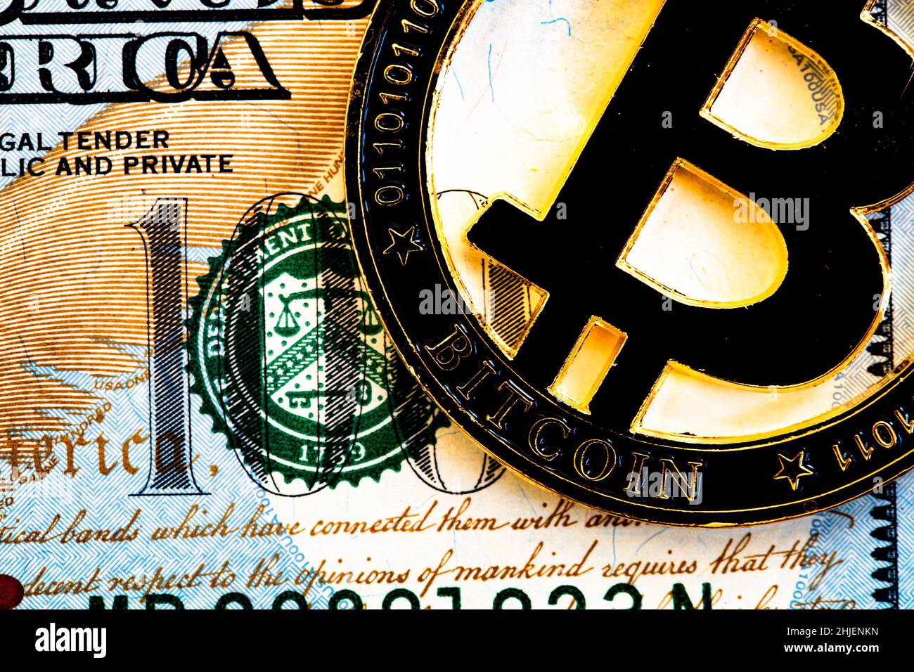 Bitcoin on 100 dollar bill background for design purpose Stock Photo - Alamy