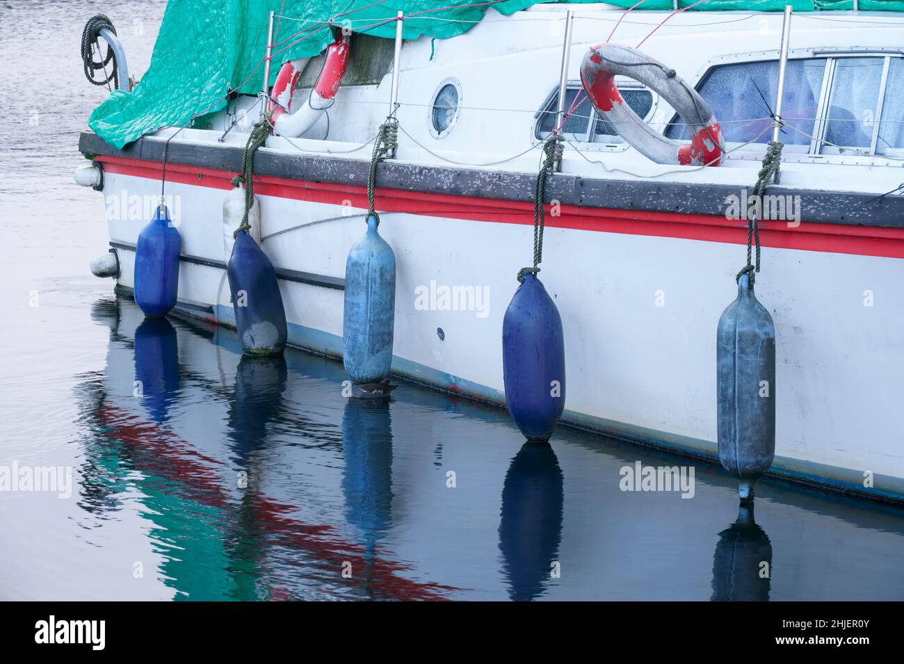 Barge boat with buoy floats along side on canal Stock Photo Alamy