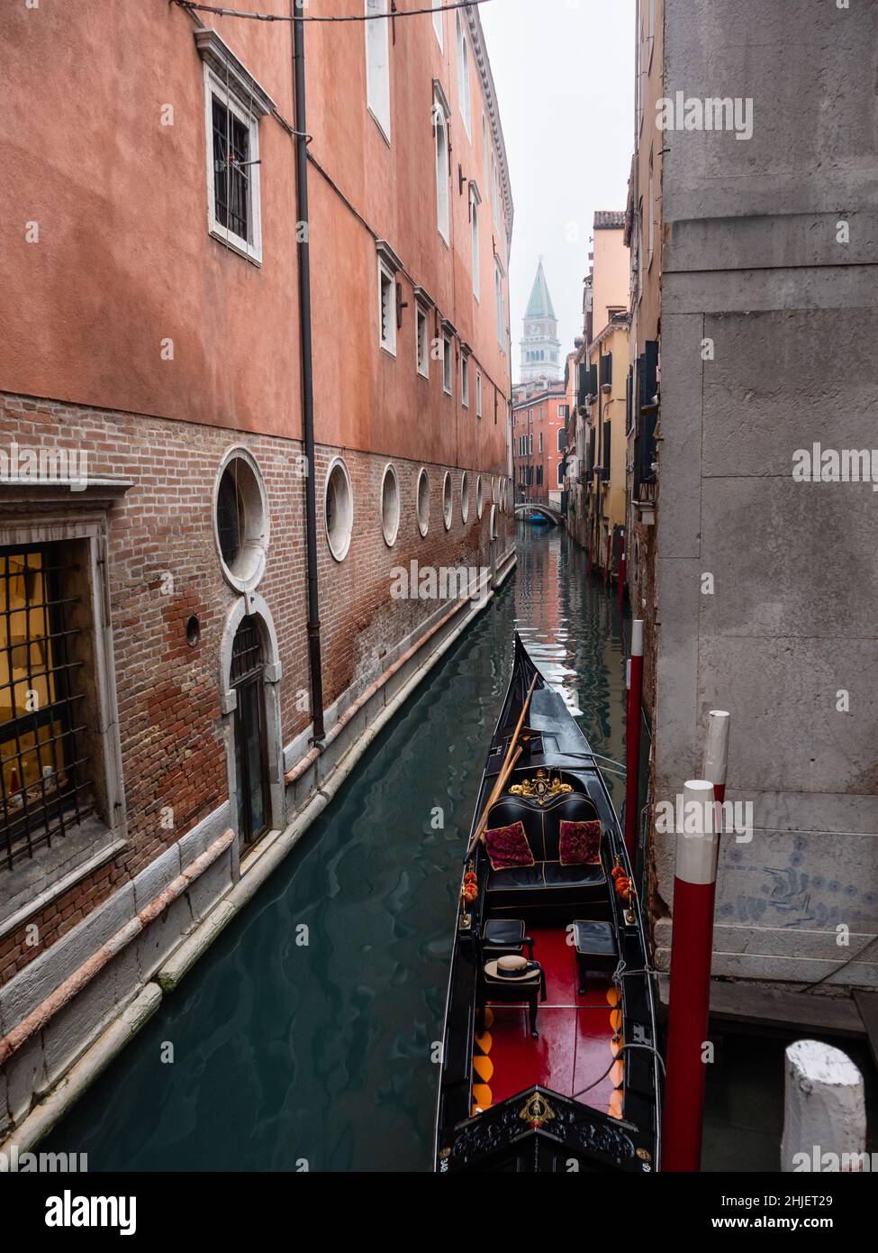 Narrow Venice Canal with a Gondola on a Winter Day Stock Photo