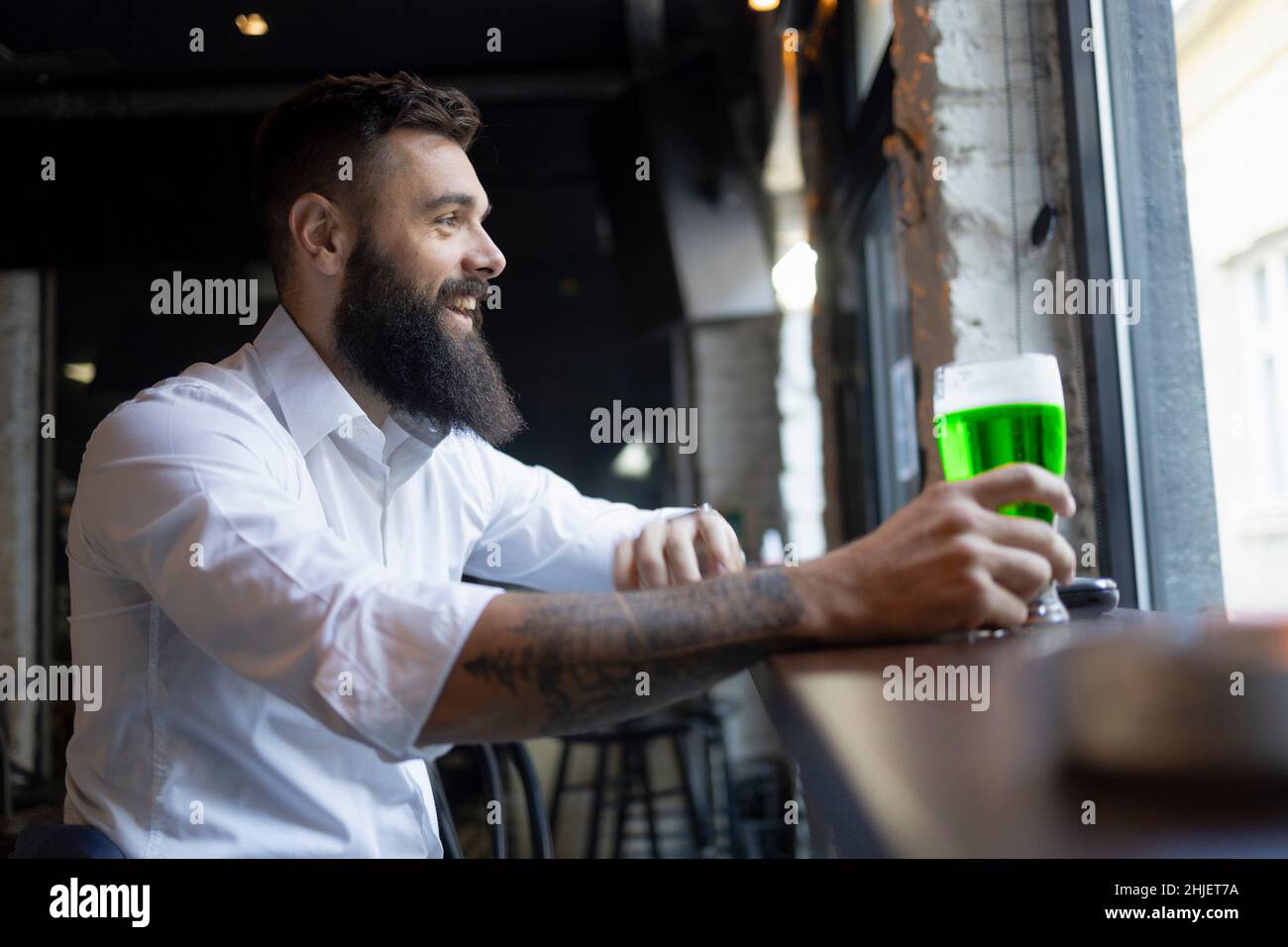 Happy man sitting in a bar for the St. Patrick's Day Stock Photo