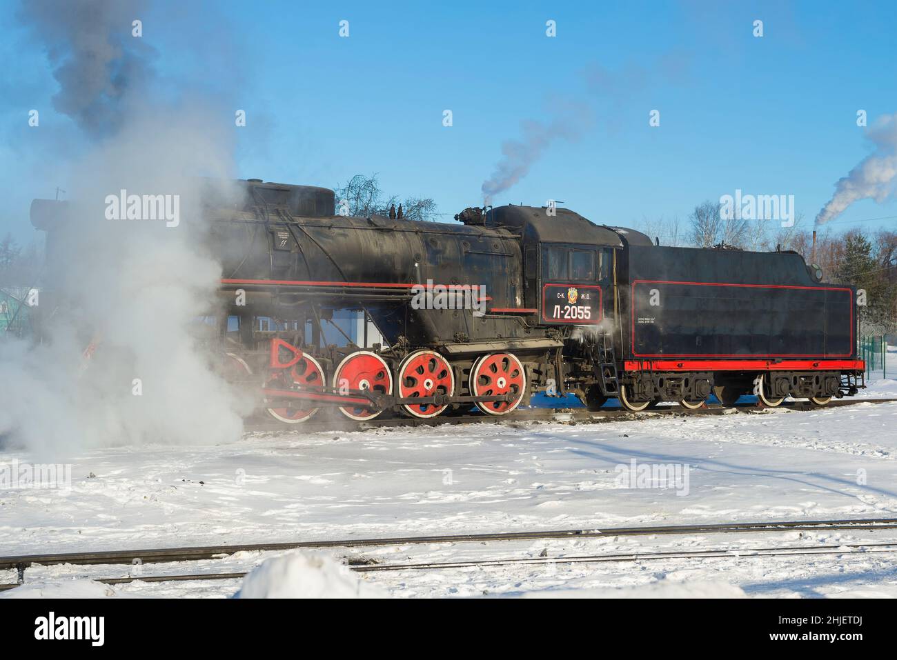 SORTAVALA, RUSSIA - MARCH 10, 2021: Old Soviet freight steam locomotive L-2055 on station access roads on a sunny winter day Stock Photo