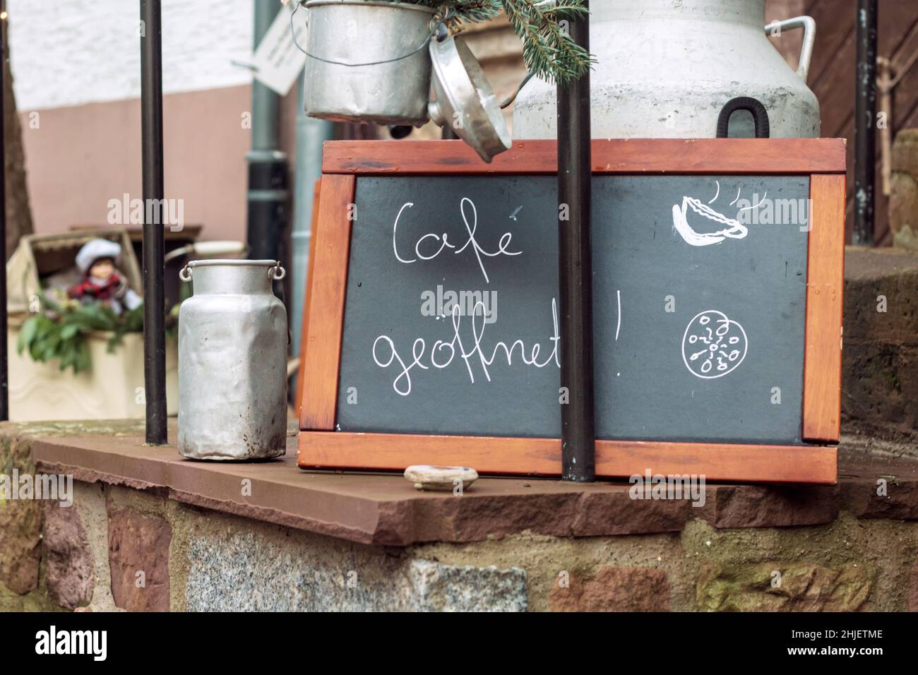 blackboard with the handwritten message with the german words for cafe open in front of a small restaurant in a german old town. Stock Photo