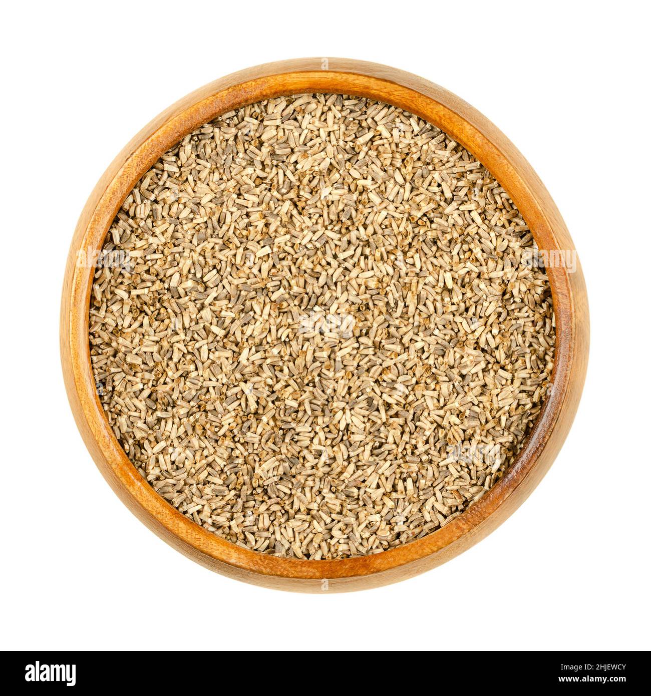 Common chicory seeds, in a wooden bowl. Cichorium intybus, plant of daisy family Asteraceae, with blue flowers. Seeds for growing microgreens. Stock Photo