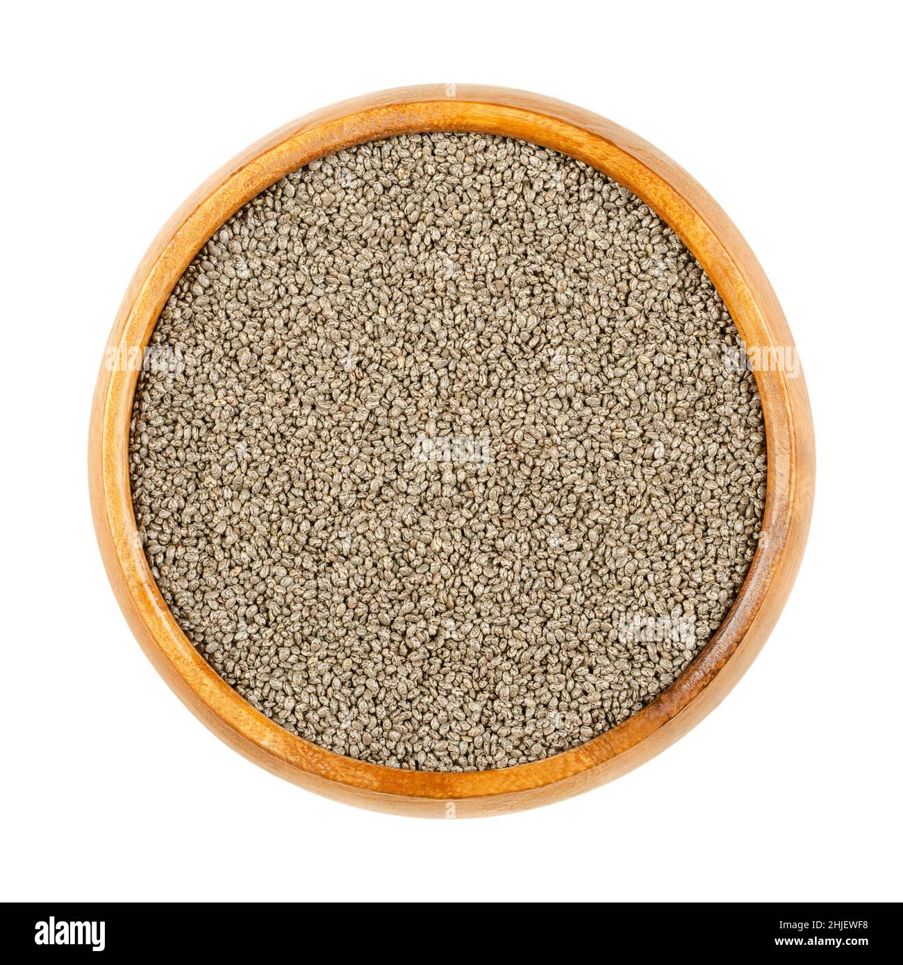Chia seeds, in wooden bowl. Edible seeds of Salvia hispanica, flowering plant in mint family (Lamiaceae). Very hygroscopic, giving food a gel texture. Stock Photo