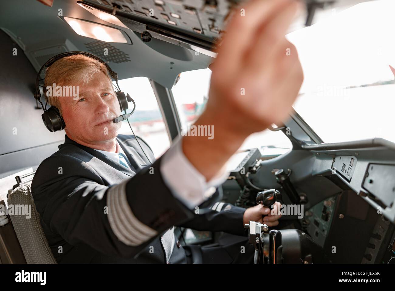Man pilot in headphones controlling aircraft flight Stock Photo Alamy