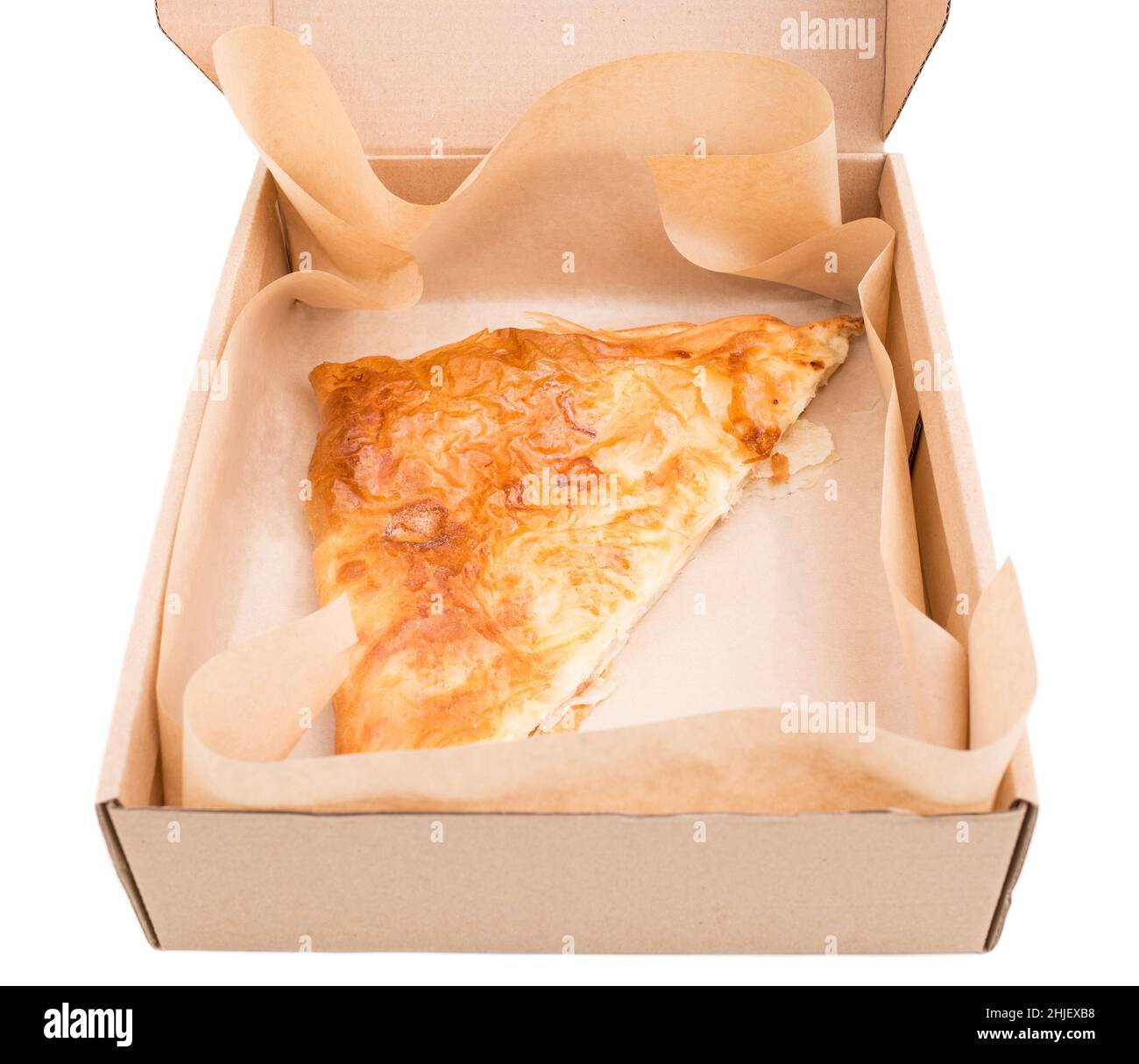 Heat puff cakes filled with a curd cheese in cardboard box. Isolated on