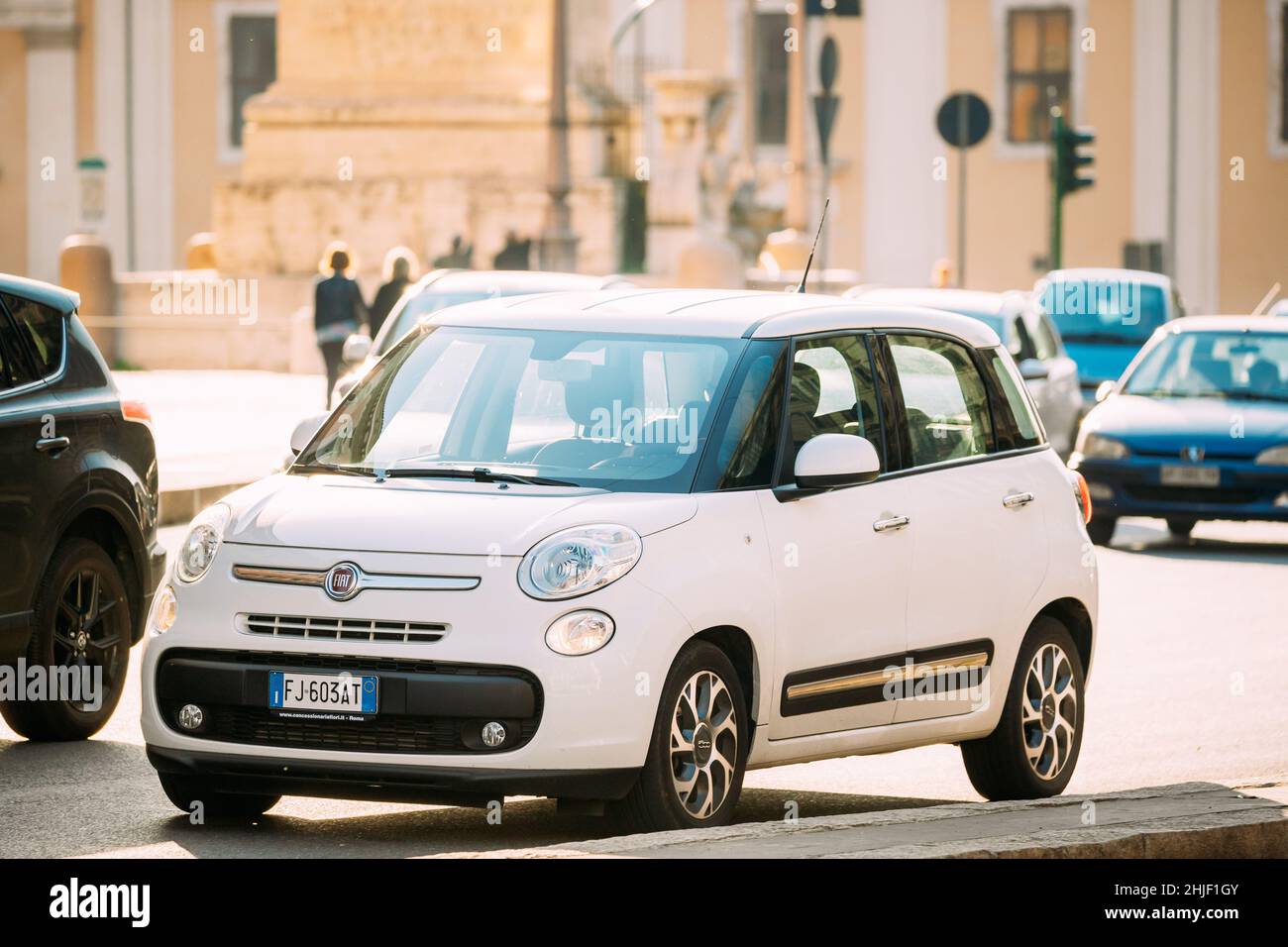 Rome, Italy. White Color Fiat 500L Moving At Rome Street. Five-door, five passenger, front-engine, front-wheel drive, high-roof B-segment MPV (compact Stock Photo