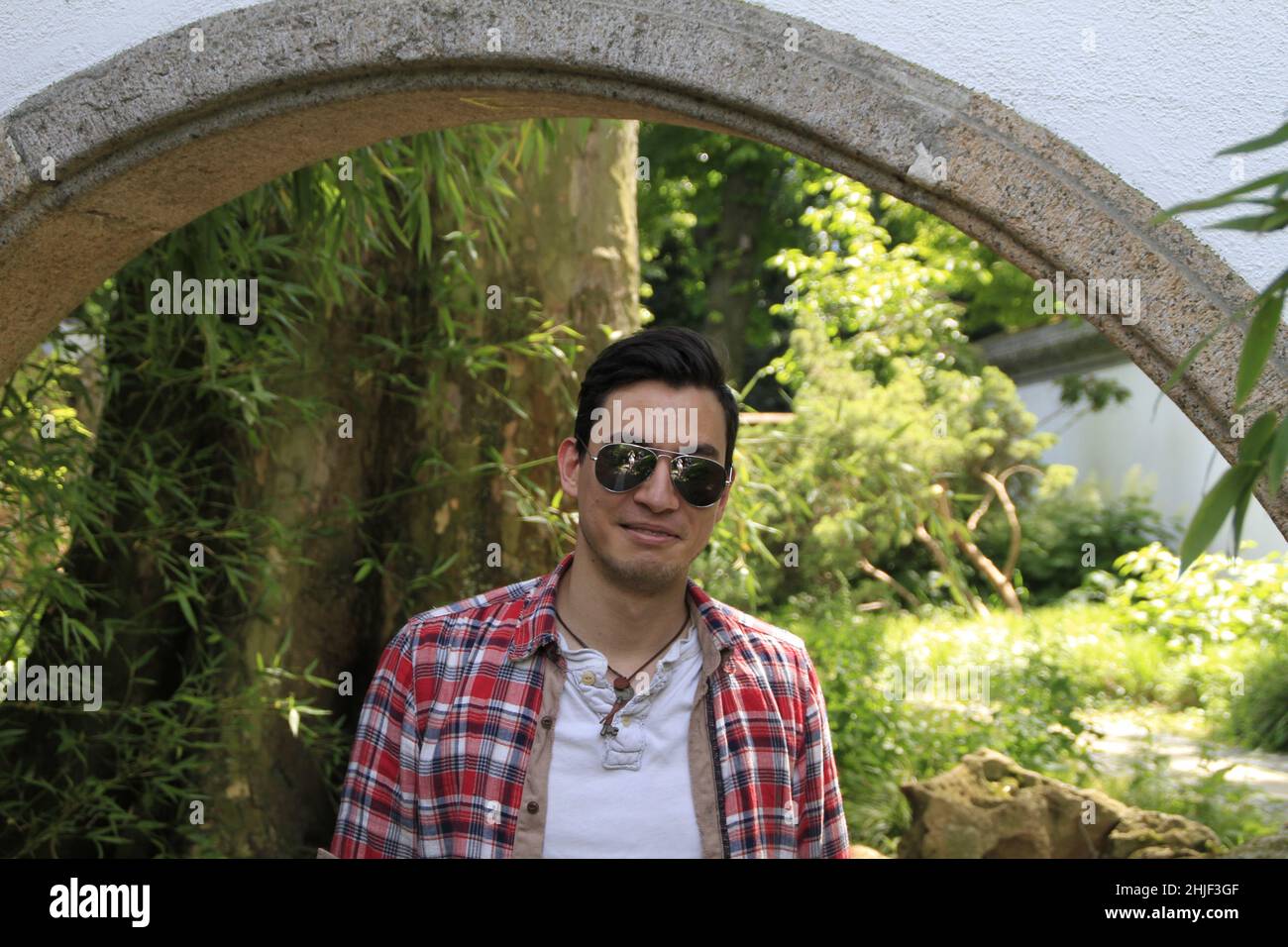 A closeup of a young man in glasses posing for the photo Stock Photo