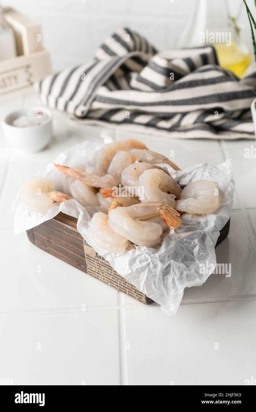 Thawed peeled shrimp, seafood, delicacy. on a white background, in a ...