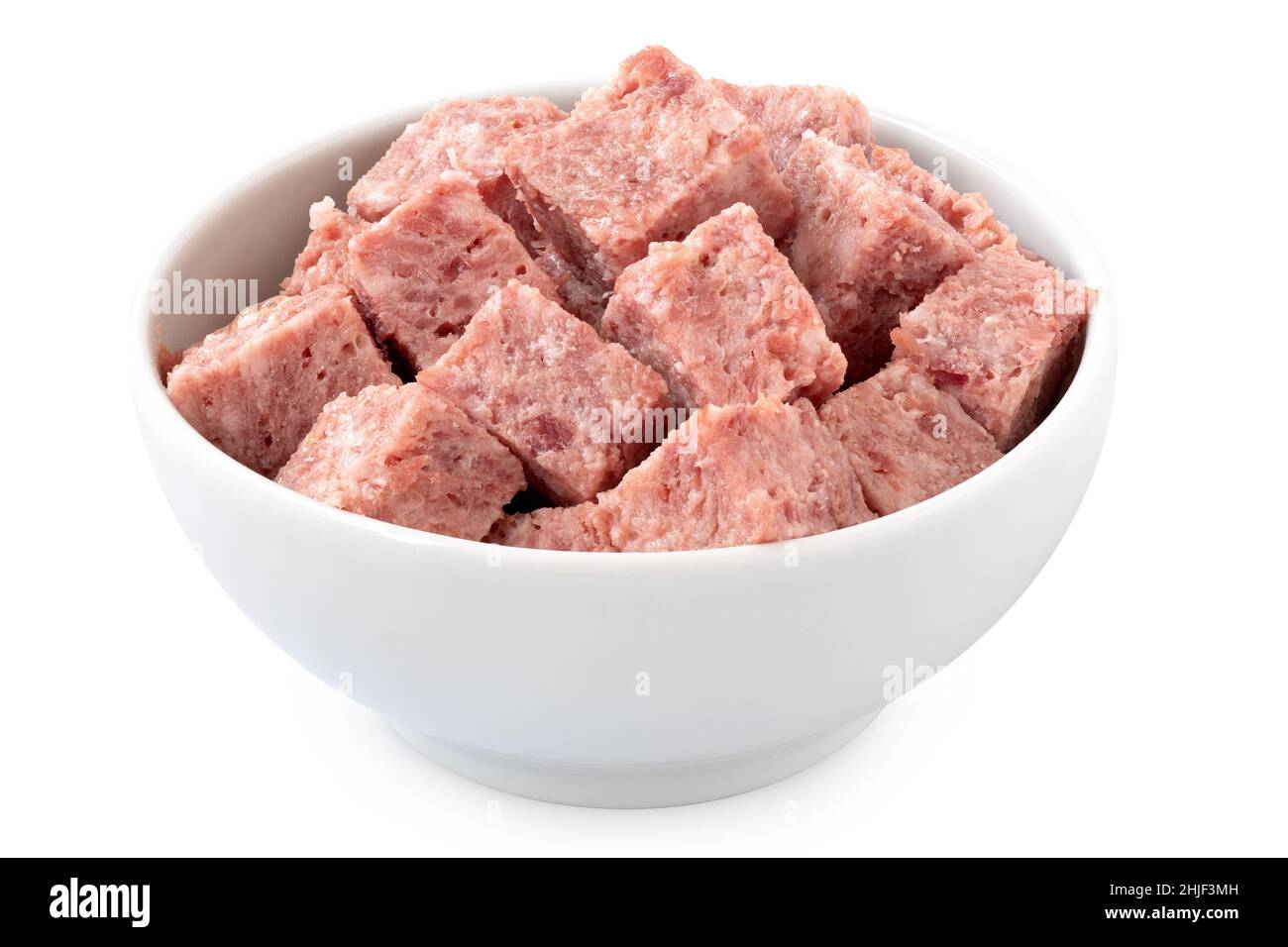 Diced pork luncheon meat in a white ceramic bowl isolated on white. Stock Photo