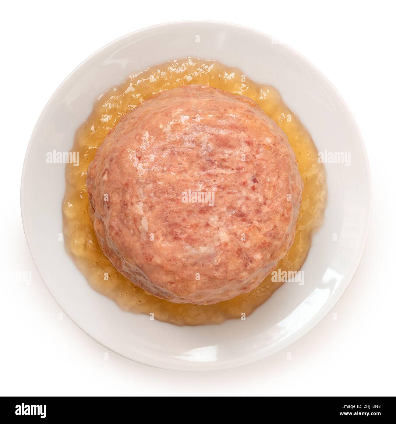 Canned pork luncheon meat surrounded by jelly on white plate isolated