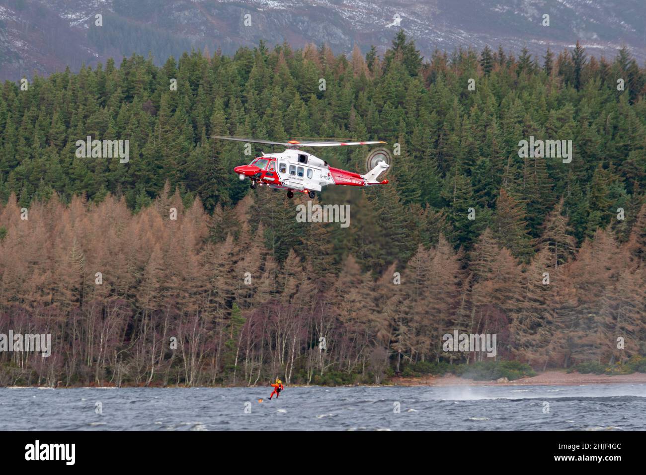 Inverness Coastguard Helicopter practicing winching at Loch Ness Stock Photo