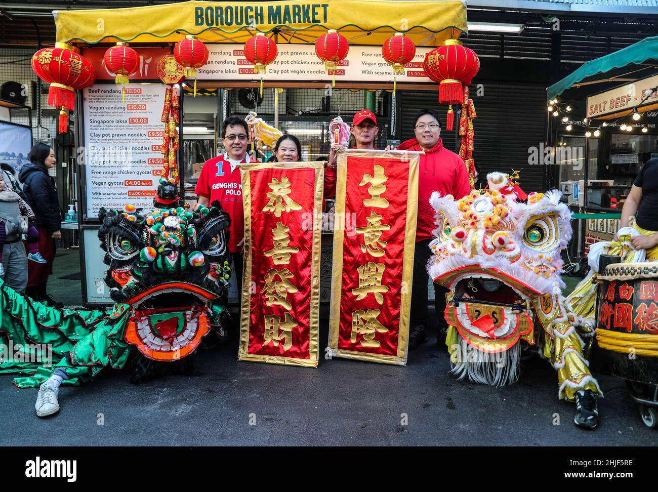 London UK 29 January 2022 A Traditional Dance to mark the star of a new year, Chinese new year of the Tiger  to mark Lunar New Year, chef Salina Khairunnisa, who runs the Joli stand in the Borough Market Kitchen, organized  a spectacular lion dance through the Market – a traditional harbinger of good luck in parts of east and southeast Asia. Joli, which specialises in Malaysian clay pot cooking, will also be offering a special New Year dish on its menu as part of the celebration: Prosperity clay pot noodles. Paul Quezada-Neiman/Alamy Live News Stock Photo