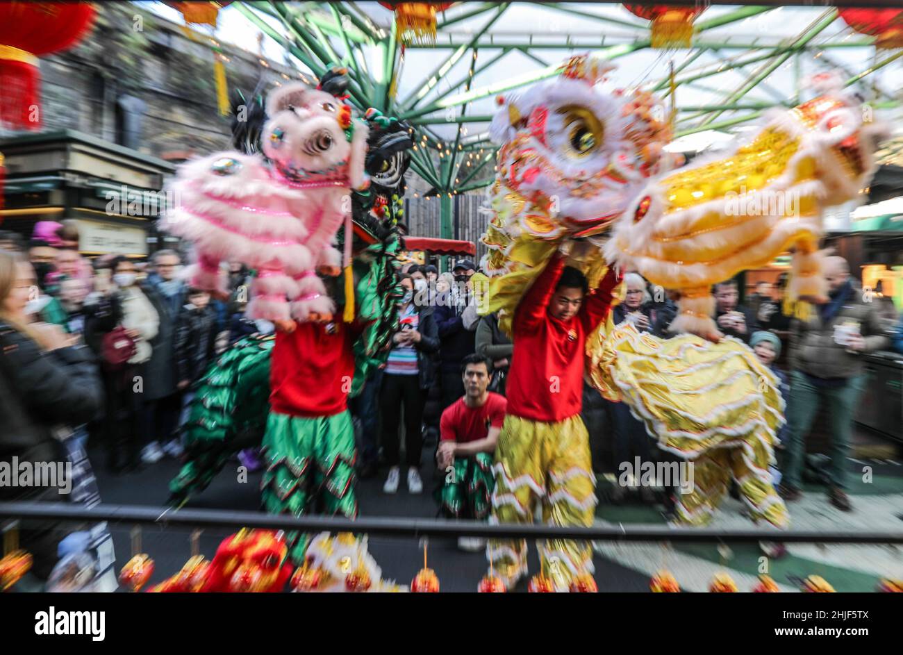 London UK 29 January 2022. As celebrations for Chinese New Year in London have been called off ,due to the pandemic, Joli stand in the Borough Market Kitchen organized a Lion dance performed by Tangs PakMei group of Soho London, Delighting the large crowd who comes to Borough Market this lovely sunny morning Paul Quezada-Neiman/Alamy Live News Stock Photo