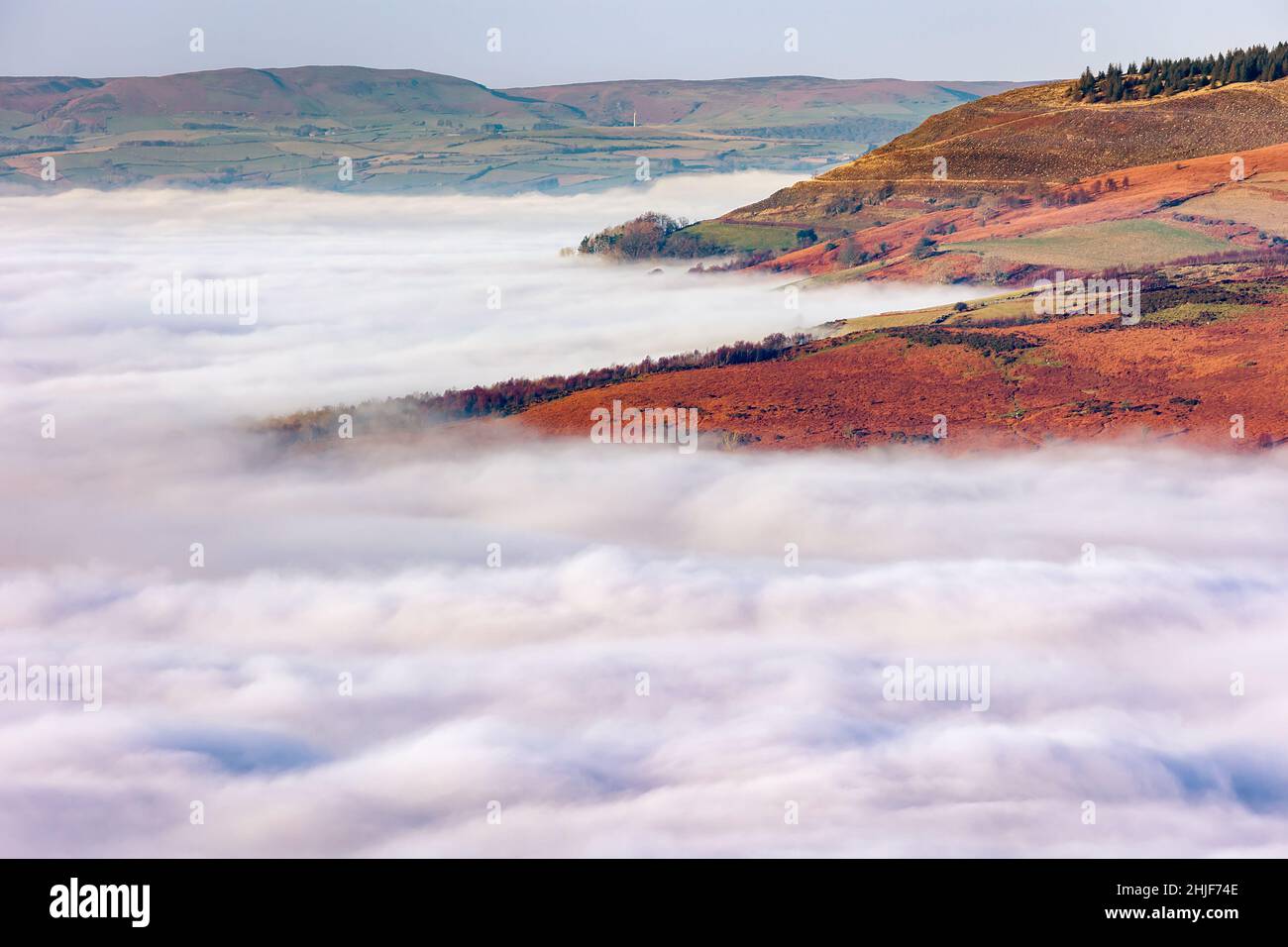 Mountains and trees showing through low level fog and cloud inversions ...