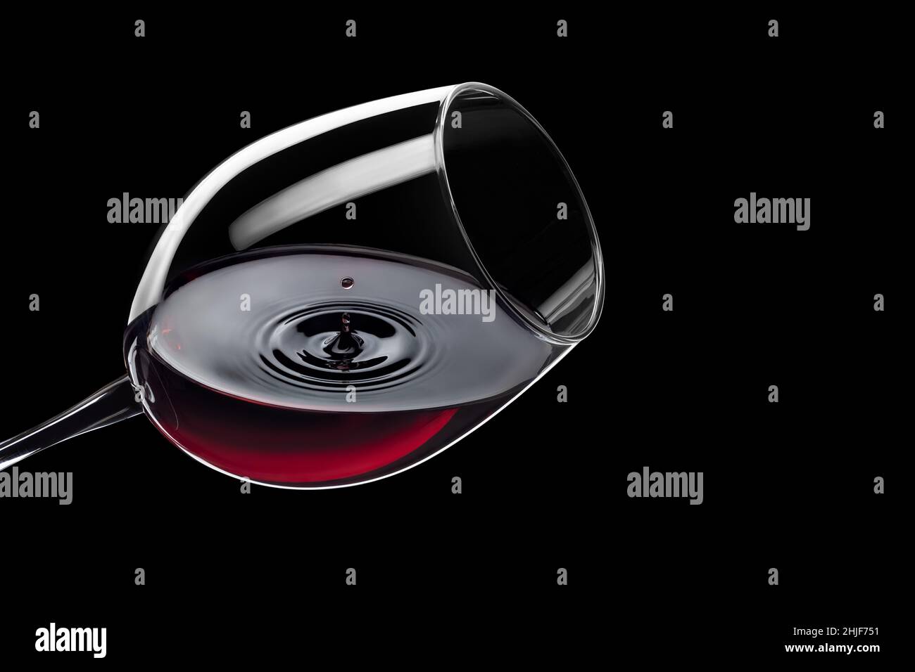 red wine drop falling in glass and created splash Stock Photo - Alamy