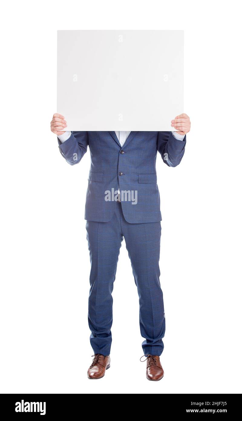 Anonymous businessman covering head with a blank banner, like a mask to hide emotions. Full length incognito person with hidden face isolated on white Stock Photo