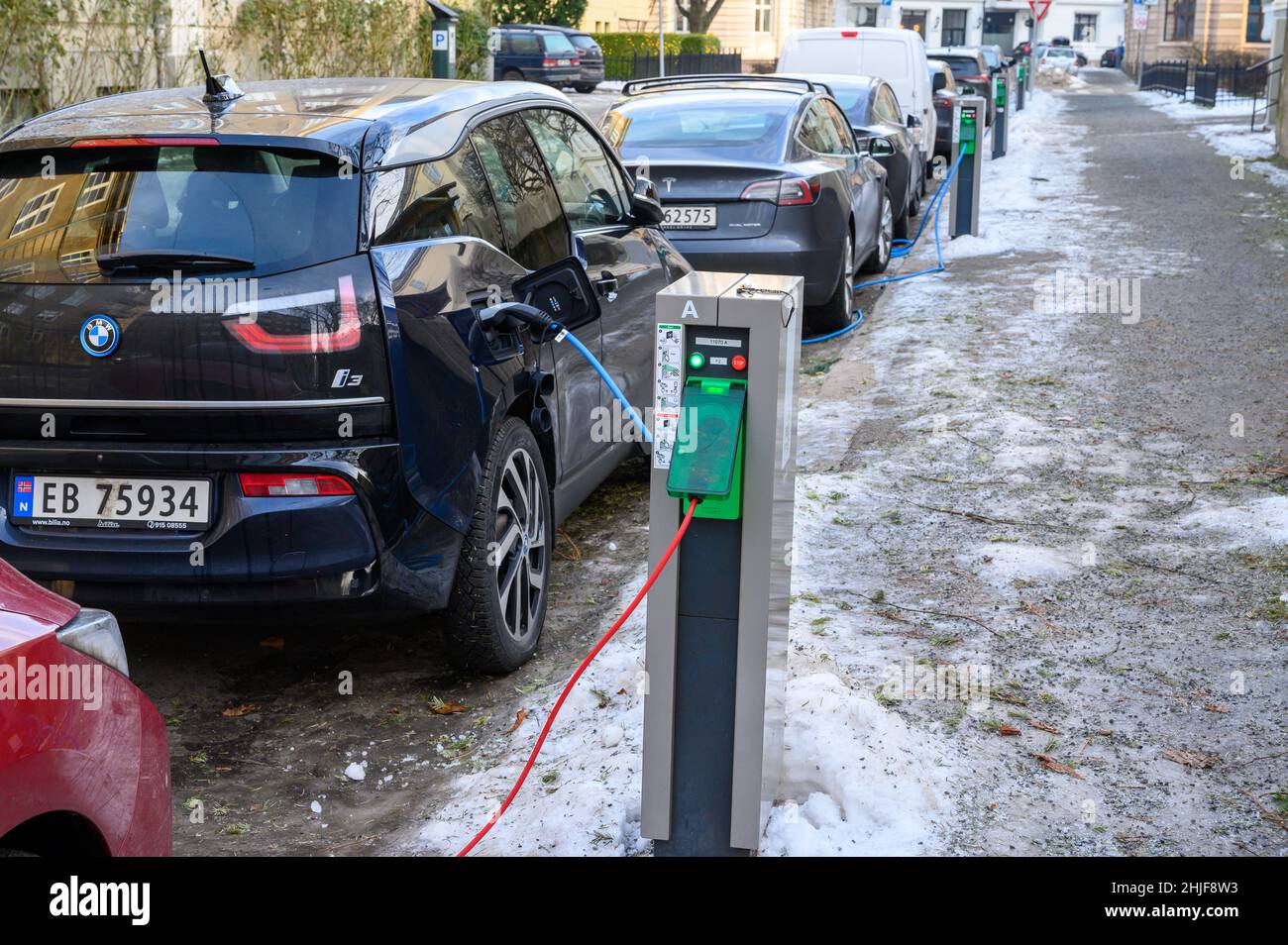 Public charging points for electric vehicles on a residential street in Oslo, Norway in winter, January 2022. Stock Photo