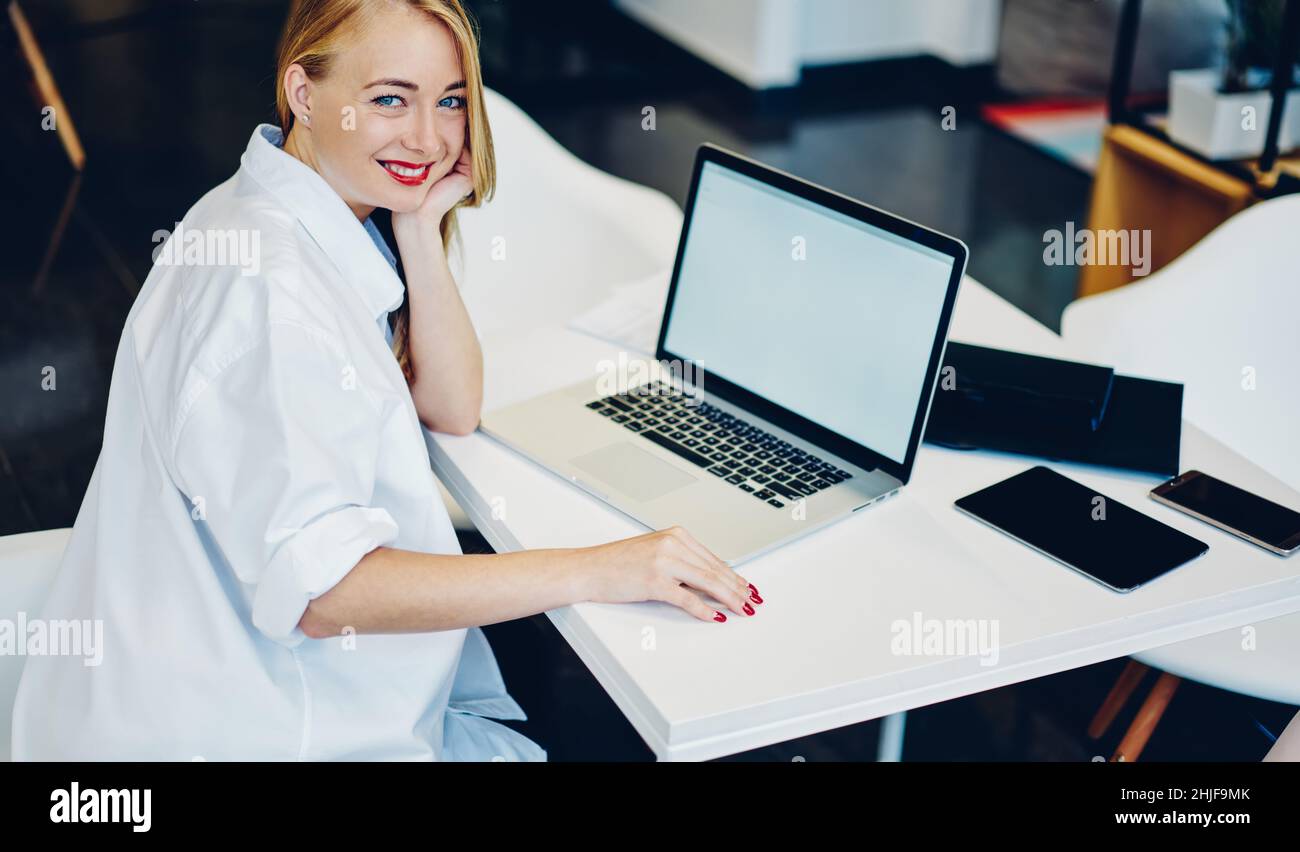 Woman with toothy smile and laptop Stock Photo