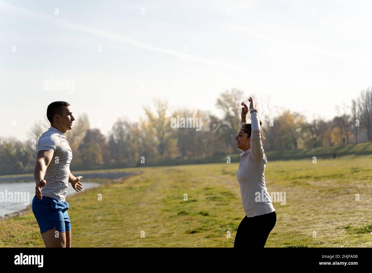Two amazing and fit friends are doing a jumping jet exercise, close up