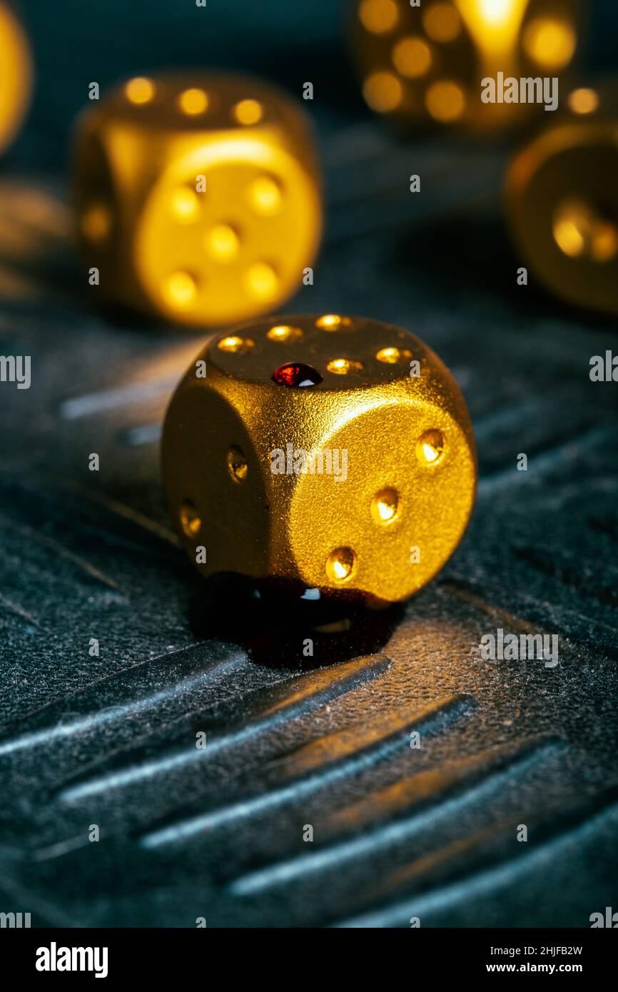 Golden dice with blood drops Stock Photo