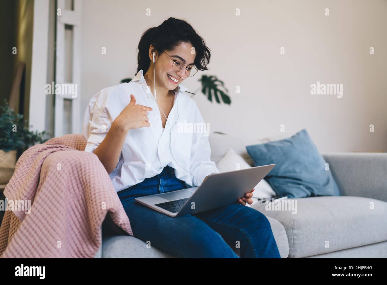 Happy woman having video chat via laptop at home Stock Photo