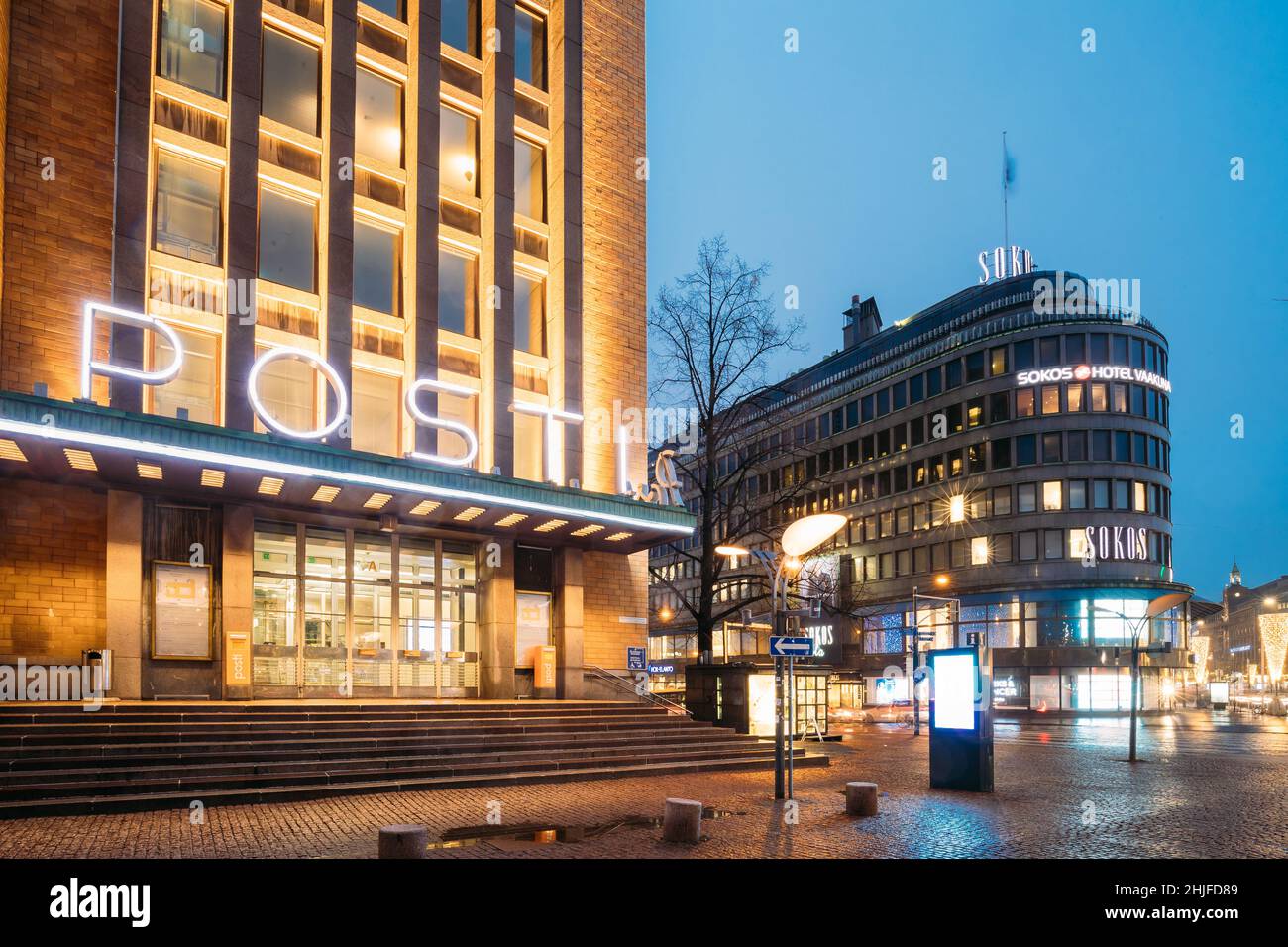 Helsinki, Finland. Post Office Building And Original Sokos Hotel In Evening Night Illumination. Stock Photo