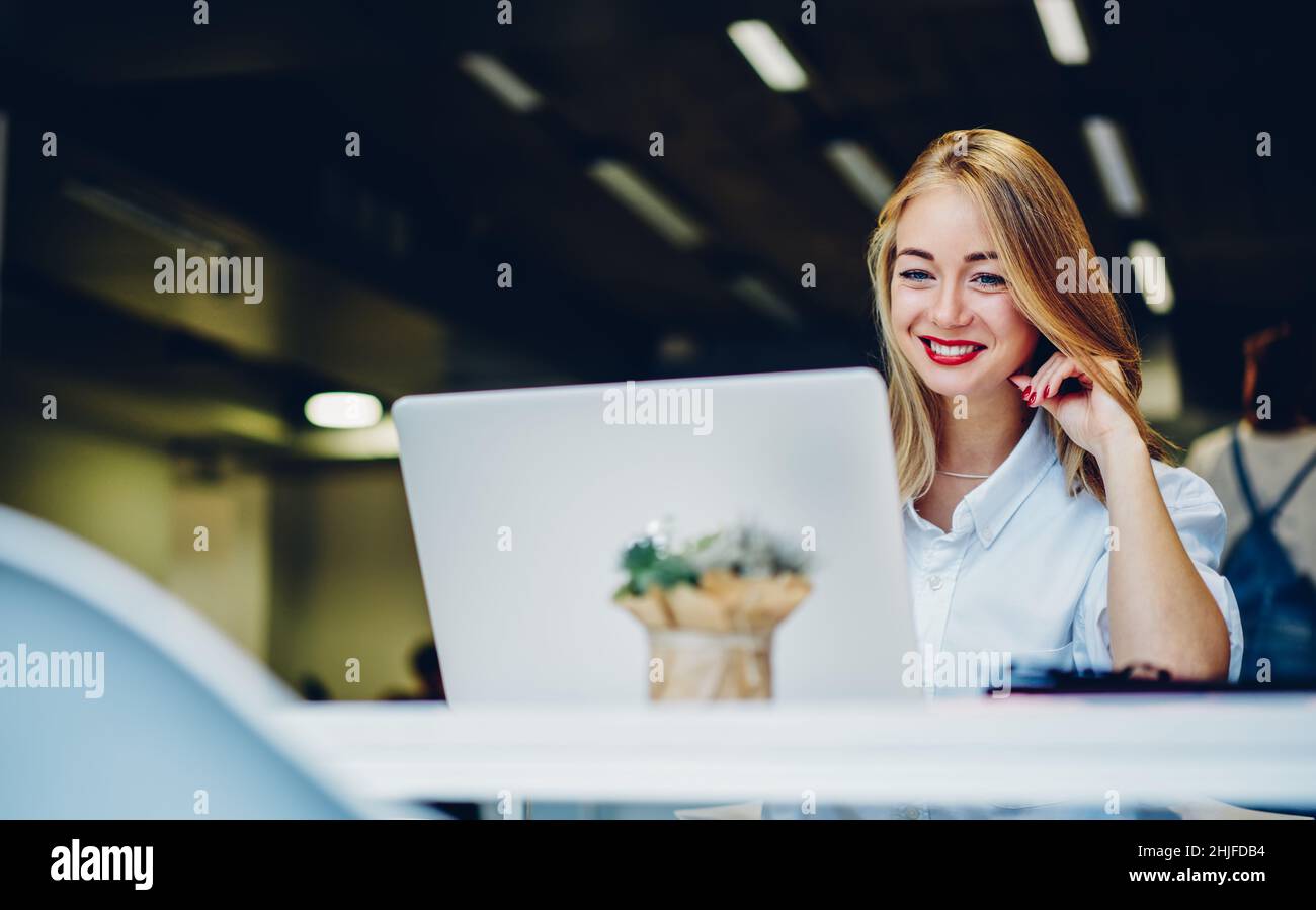Remote worker sitting with laptop at workplace Stock Photo