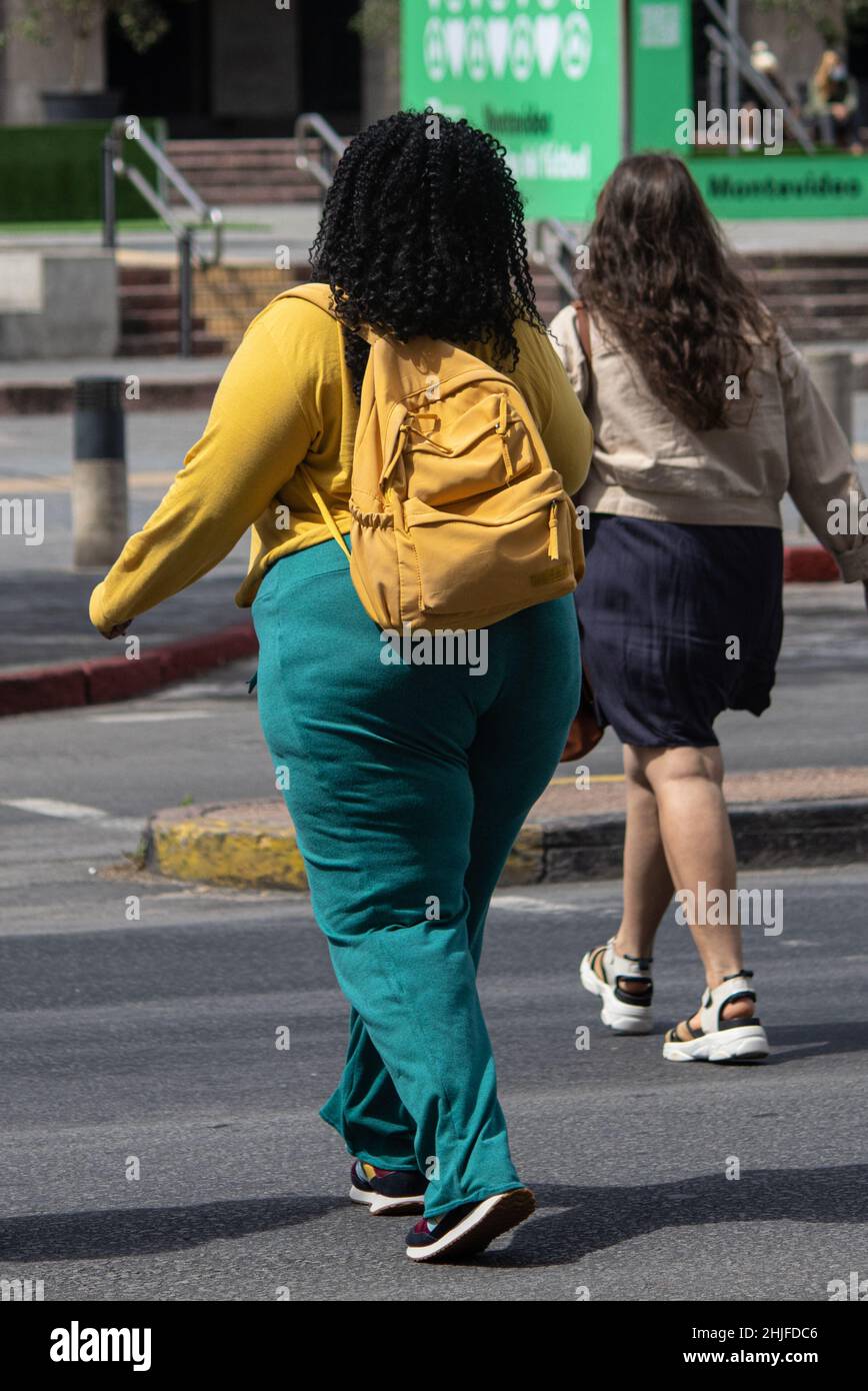 Vertical shot of two girls walking in the street Stock Photo - Alamy