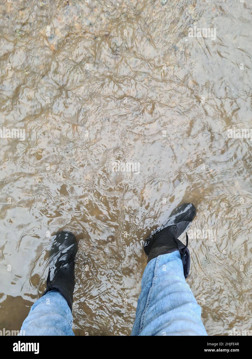 Rubber boots in the water Stock Photo Alamy