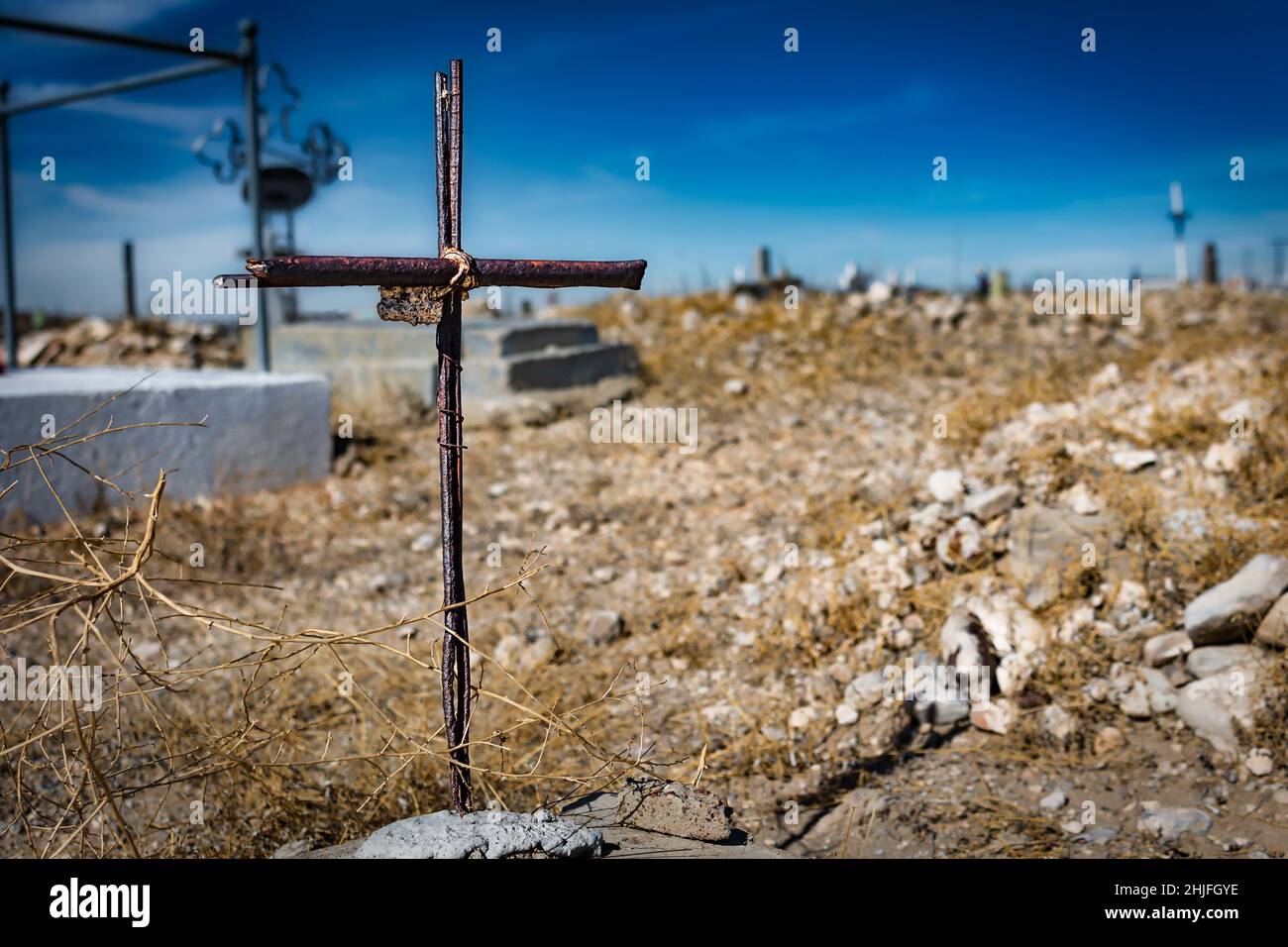 A weathered and rusted wrought iron cross at the historic Smeltertown