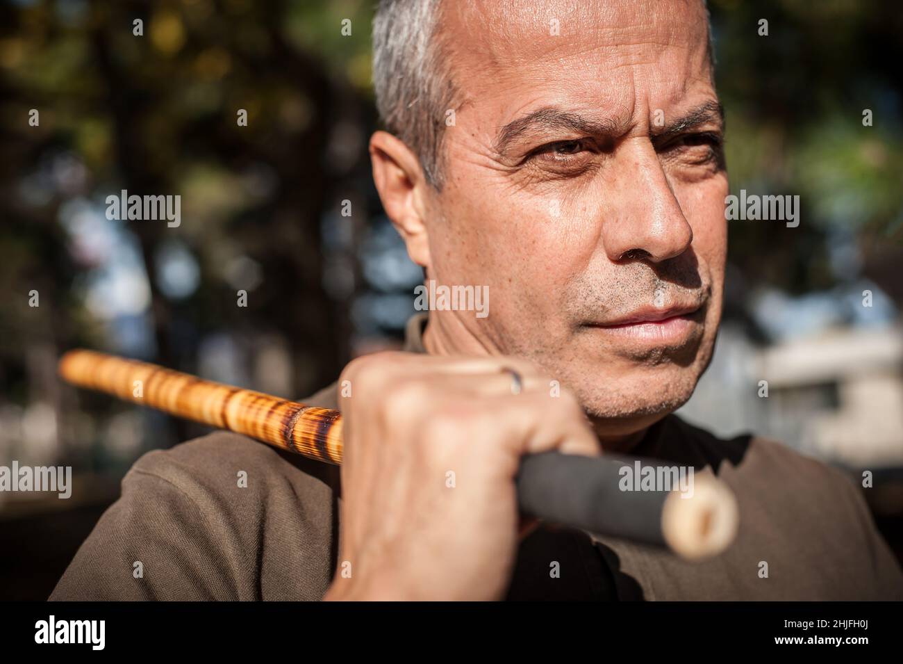 Escrima and kapap instructor demonstrates sticks fighting techniques in