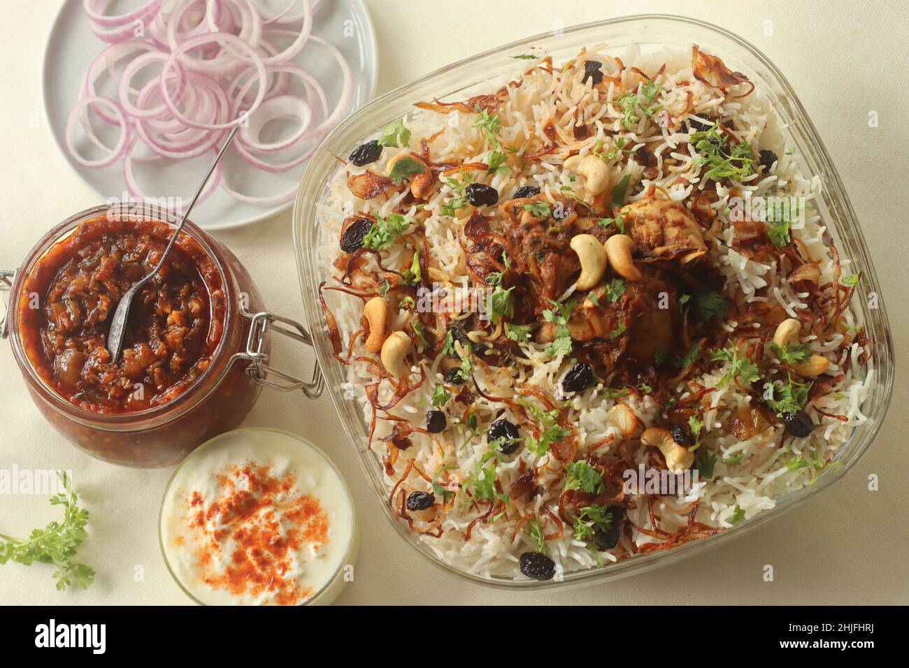 Ghee rice and chicken roast. A rice dish made of basmati rice, ghee, spices and garnished with fried onions, cashews and raisins. Served with kerala s Stock Photo