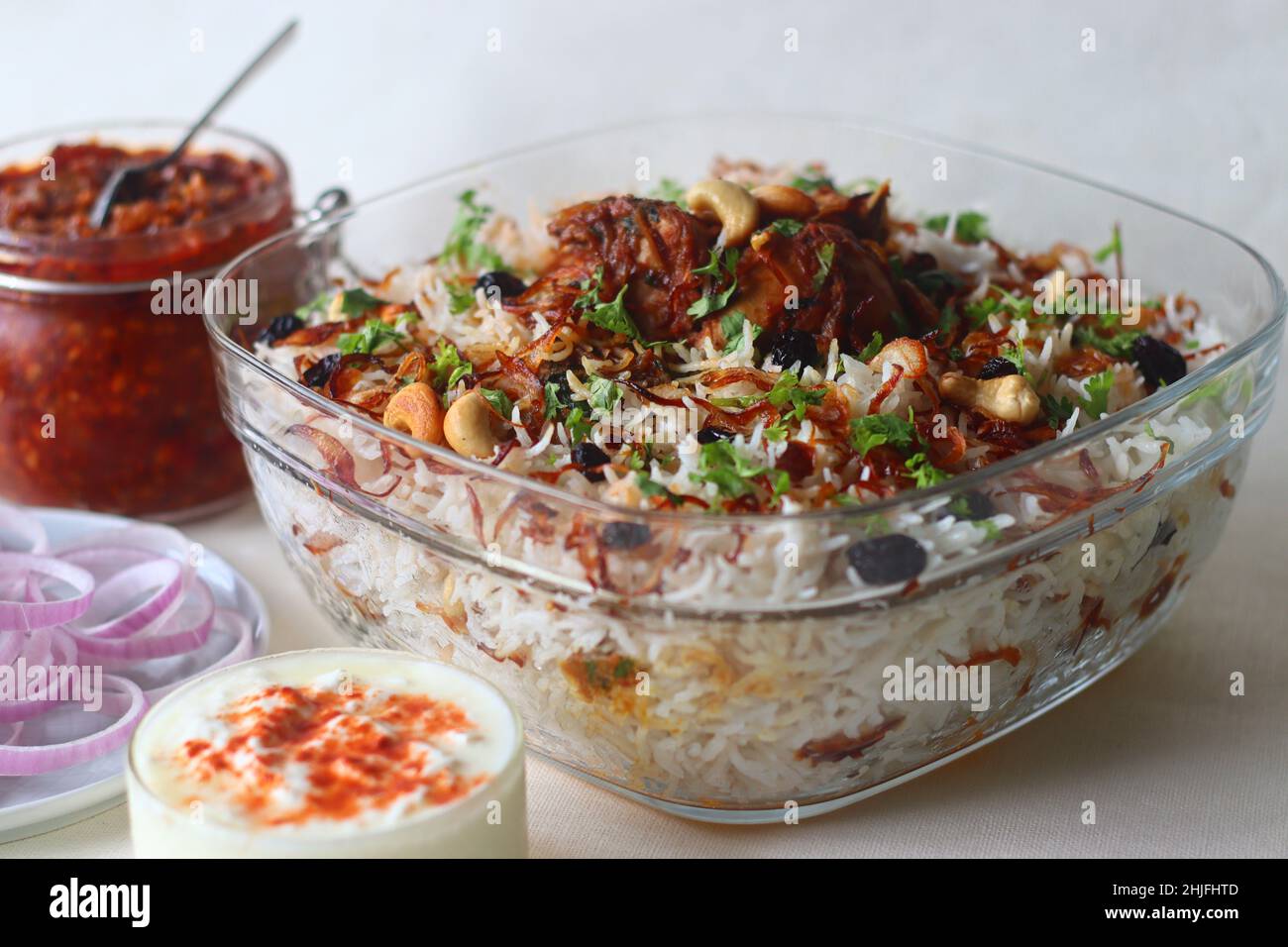 Ghee rice and chicken roast. A rice dish made of basmati rice, ghee, spices and garnished with fried onions, cashews and raisins. Served with kerala s Stock Photo