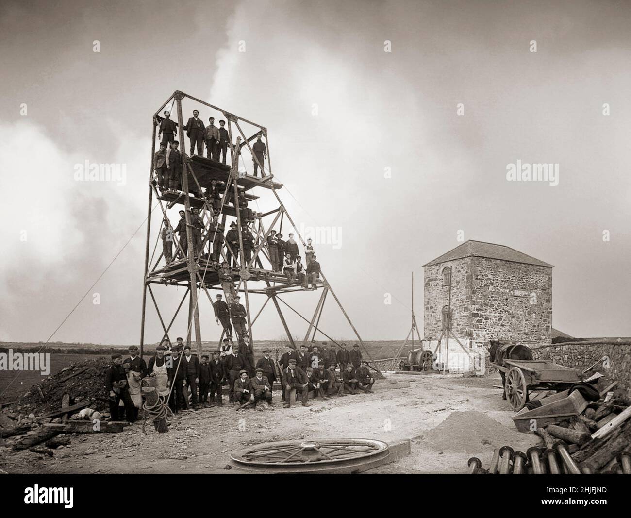 A vintage photograph of miners at Knockmahon, near Bunmahon, County Waterford, Ireland, shot on 1906. The The Mining Company of Ireland established in 1824 took leases on mineral areas all over the country. Knockmahon proved to be the most profitable of all their operations. By 1840 it was described  as ‘the most important — mining district in the (British) empire’. This proved to be the peak, and in their search for other lodes in the neighbourhood they discovered Tankardstown just as Knockmahon was threatening to flood. Stock Photo