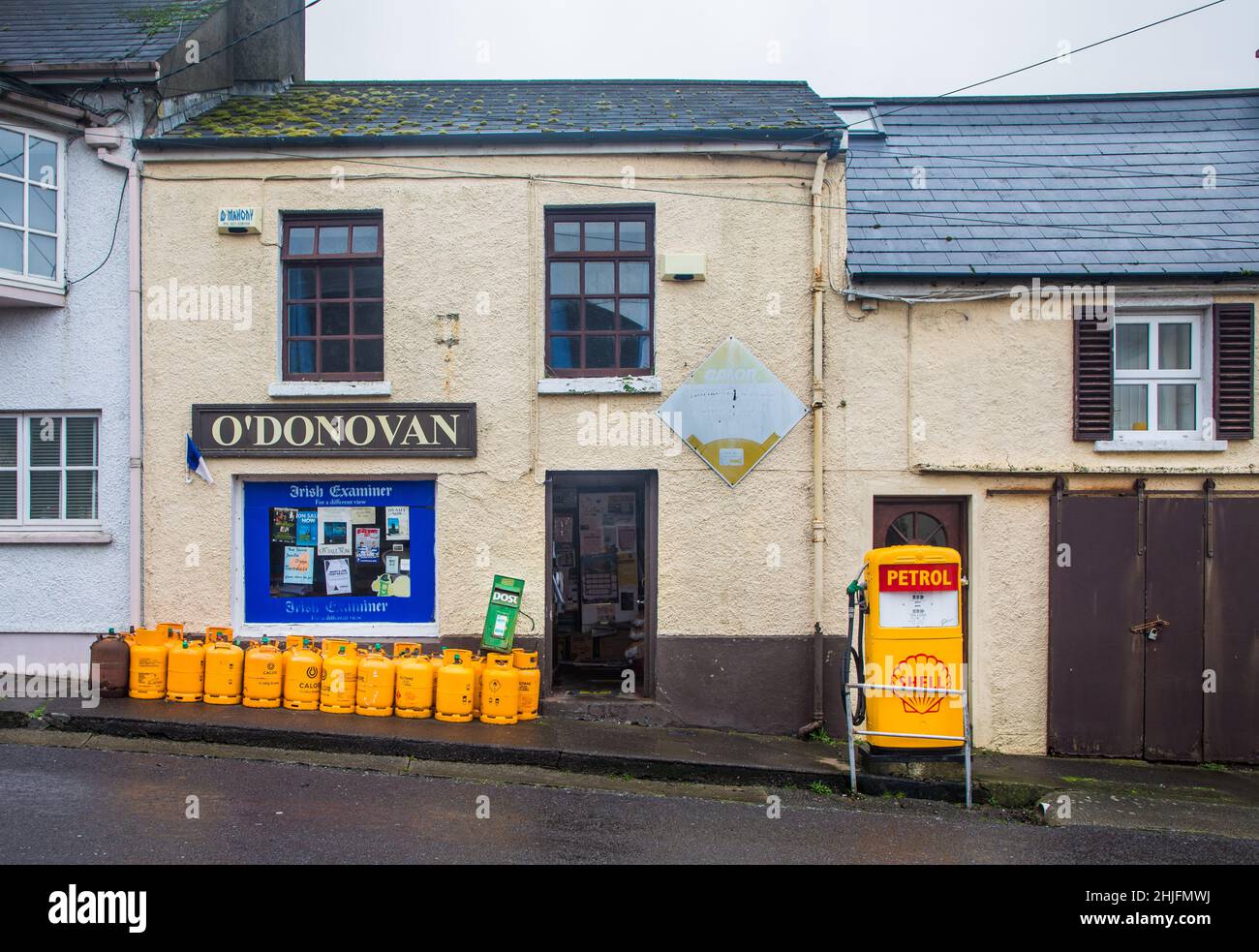 Castletownsend, Cork, Ireland. 29th January, 2022. colourful exterior of gas bottles and a vintage petrol pump at O'Donovan's shop in the holiday village of Castletownsend, Co. Cork, Ireland. - Credit; David Creedon / Alamy Live News Stock Photo