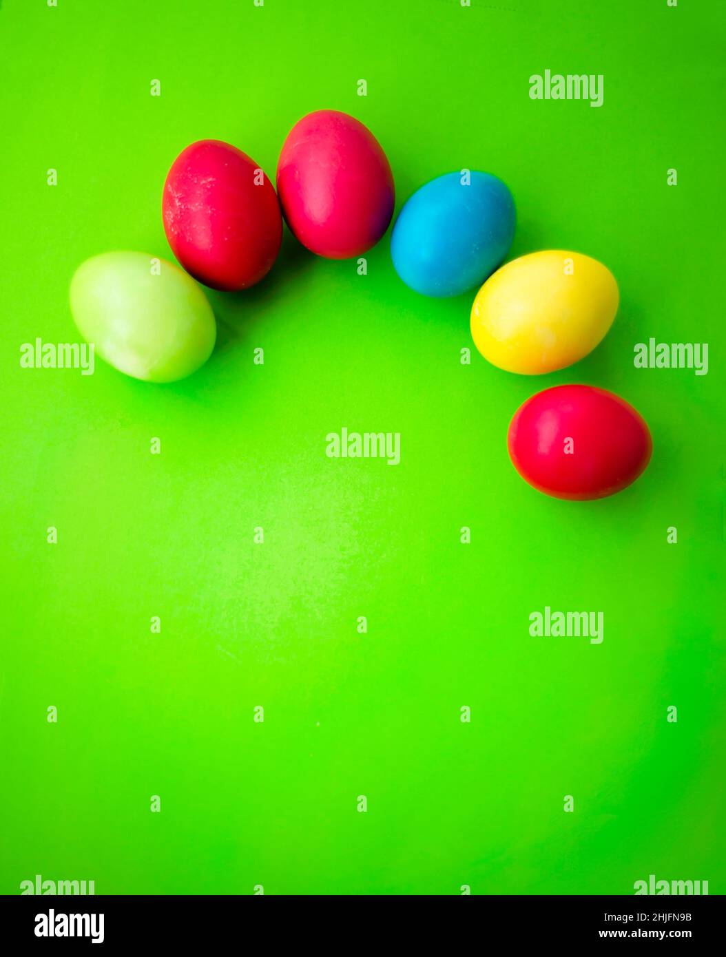 Pattern of colorful Easter eggs on a green background. Stock Photo