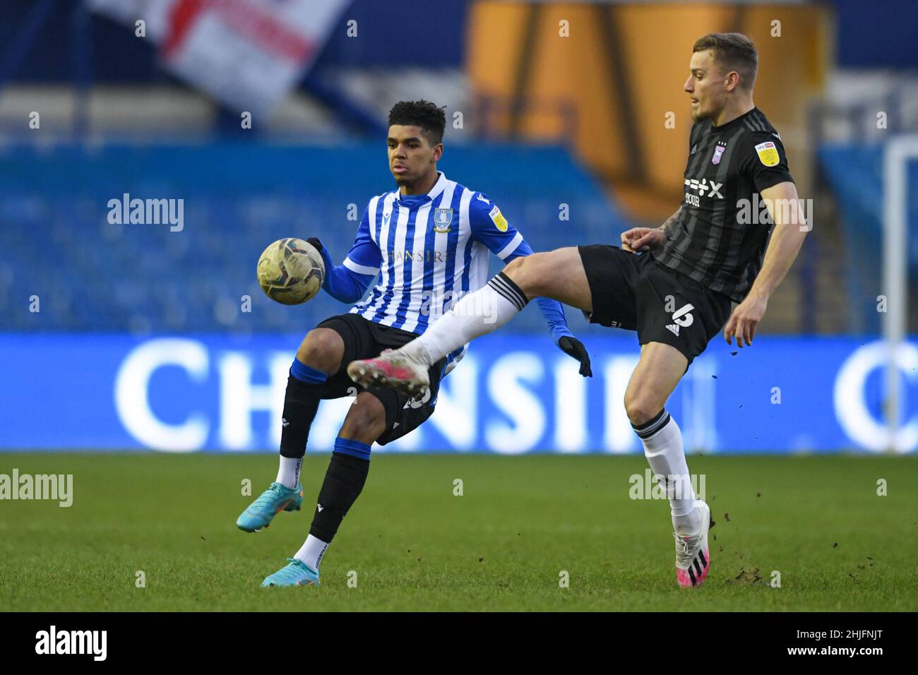 Sheffield, UK. 29th Jan, 2022. Tyreece John-Jules #30 of Sheffield Wednesday competes with Luke Woolfenden #6 of Ipswich Town for the ball in Sheffield, United Kingdom on 1/29/2022. (Photo by Simon Whitehead/News Images/Sipa USA) Credit: Sipa USA/Alamy Live News Stock Photo