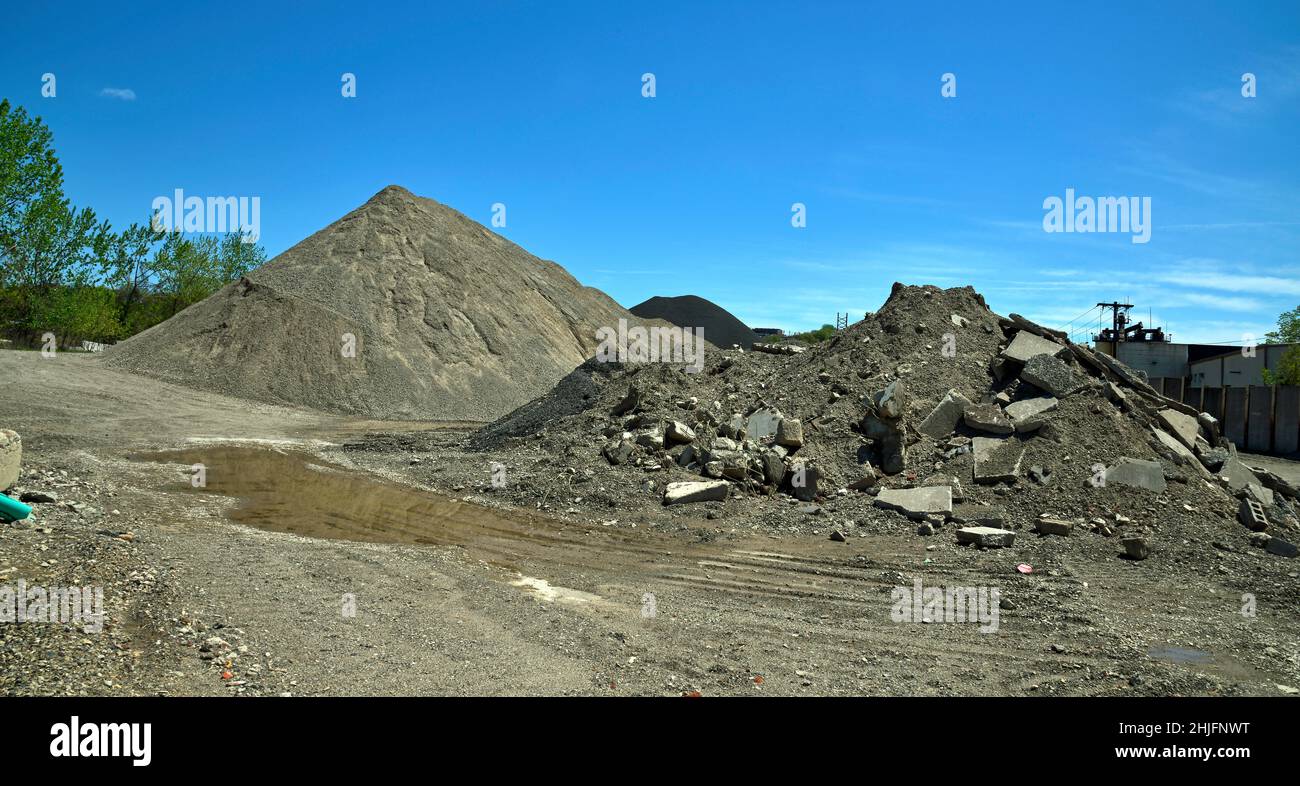Large industrial mound of gravel,sand,asphalt and macadam or road pavement and broken stone. Stock Photo