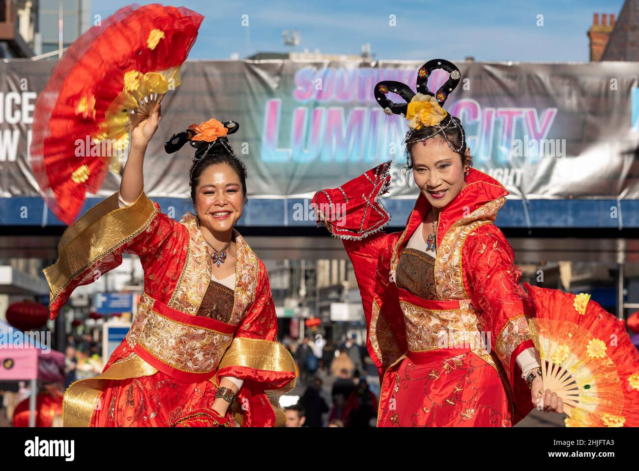Chinese New Year 2022, Lunar New Year celebration event in the High Street, Southend on Sea, Essex, UK Stilt walkers in traditional bright costumes Stock Photo