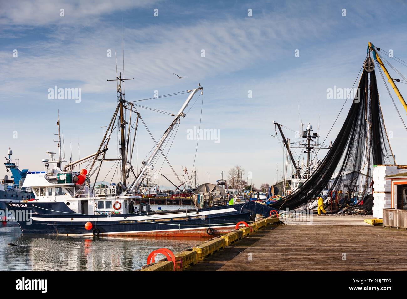 Commercial fishing vessel having a fish net removed from the net spool ...