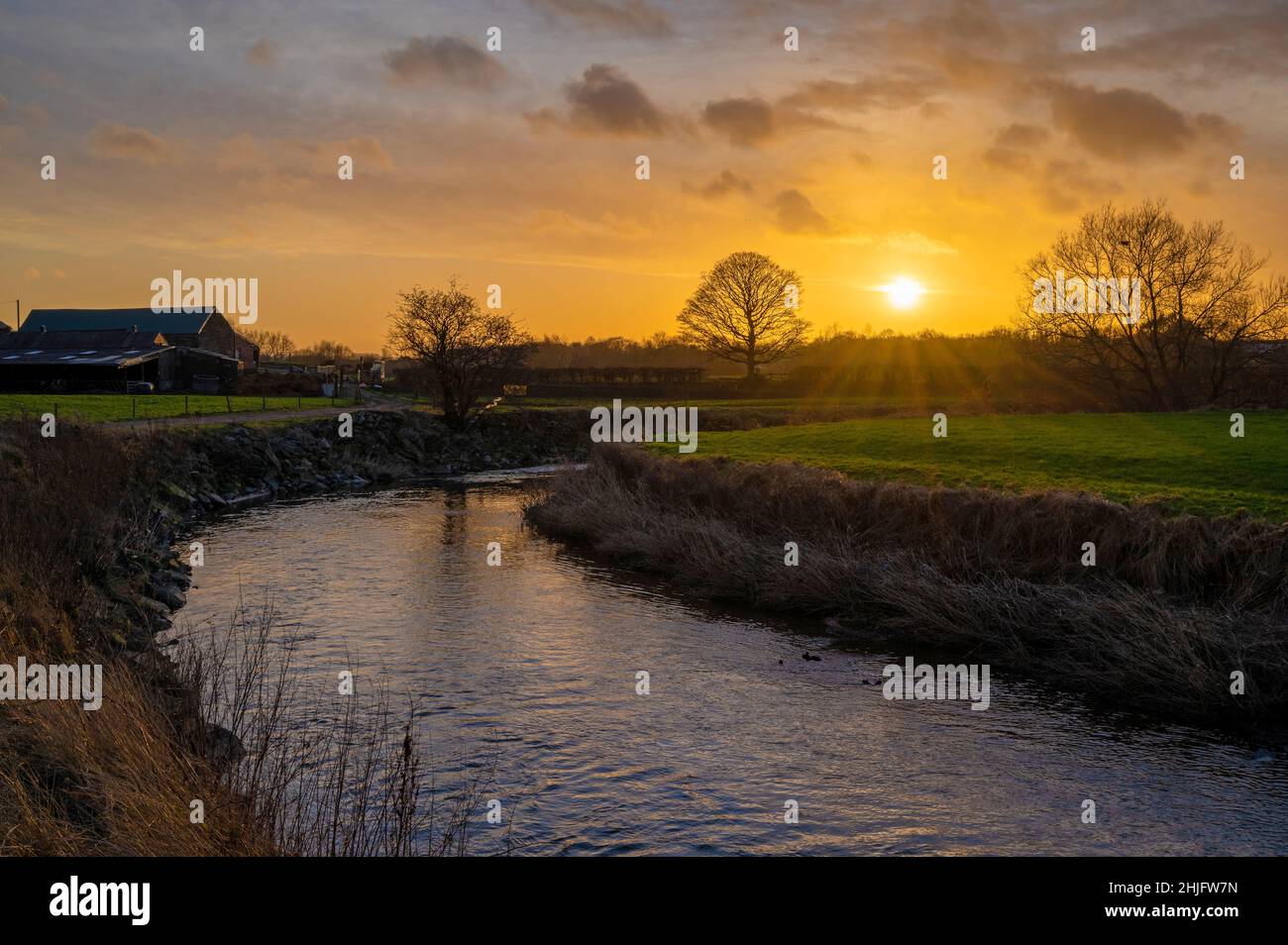 Water Farm House, River Roch, Bury, UK Weather, 29th January 2022. With Water Farmhouse on the left , Sunset strikes along the River Roch, Bury, Greater Manchester. Credit: Tom McAtee/Alamy Live News Stock Photo