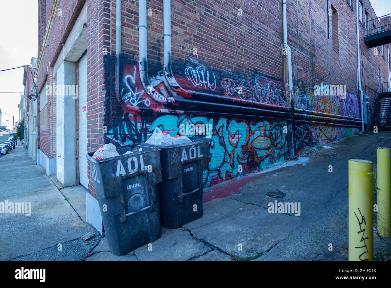 Trash bins sit in an empty alley in Winston-Salem. Stock Photo