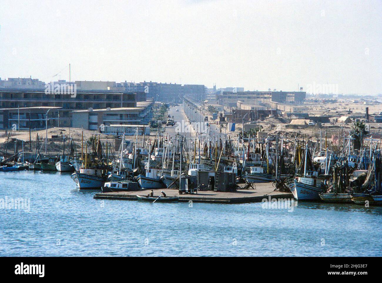 Fishing boats in harbour at Port Said, at the Mediterranean end of the Suez Canal, behind them is the dual-carriageway, El-Shaheed Atef El-Sadat. 10th February 1978 Stock Photo