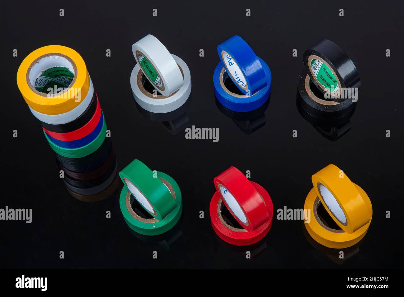 Several coils of colored tape (insulating tape) on black background