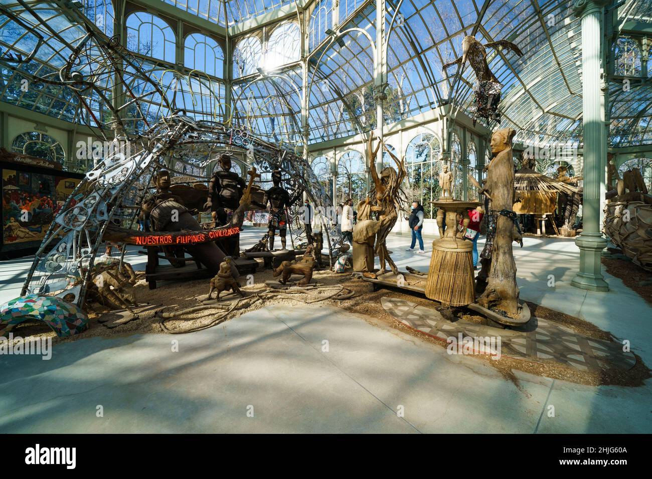 Madrid, Spain. 29th Jan, 2022. An overview of the figures that make up the exhibition 'Magellan, Marilyn, Mickey and Friar Damaso. 500 years of conquistadors RockStars', by the artist Kidlat Tahimik, at the Palacio de Cristal del Parque de El Retiro in Madrid, In this exhibition made up of wooden figures Tahimik reflects on the indigenous resistance and the cultural imposition of the imperial powers, while at the same time he proposes, with irony, an alternative narration of History to the one written by the victors. Credit: ZUMA Press, Inc./Alamy Live News Stock Photo