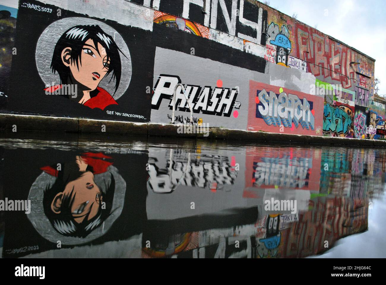 Low point of view shot of graffiti by the Hertford canal at Hackney Wick, east London. Stock Photo