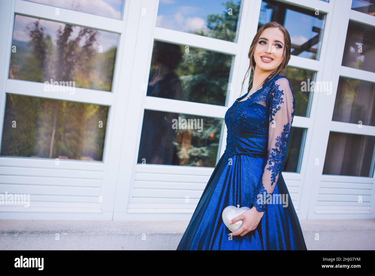 Beautiful girl in glamorous ultramarine dress. Ready for her prom night. Stock Photo