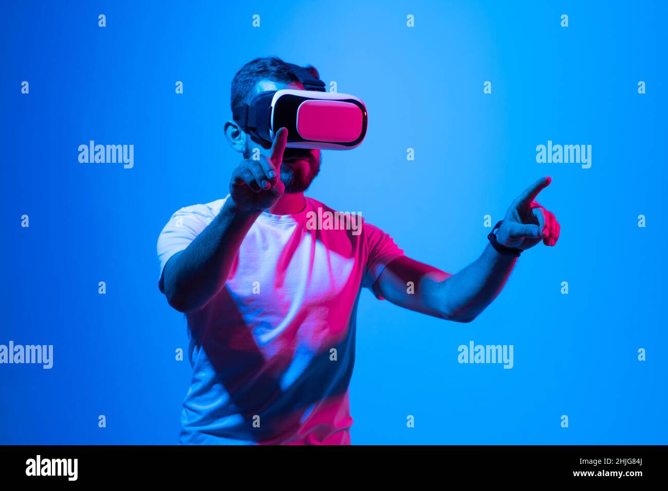 Bearded man playing VR video game in metaverse with virtual reality