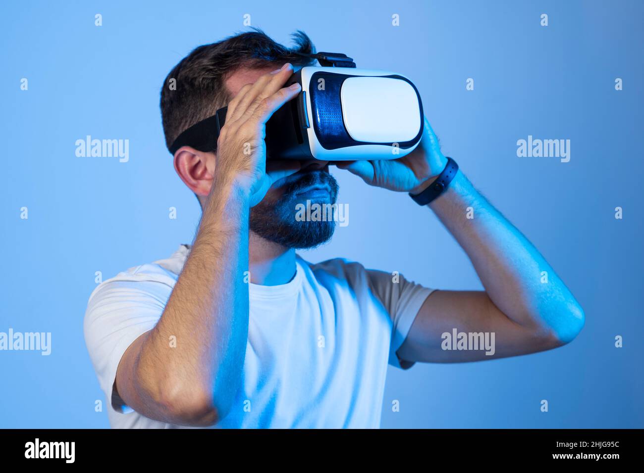 Young bearded man wearing virtual reality VR glasses goggles diving ...